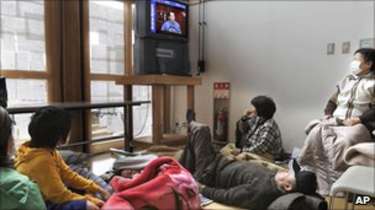 People in a temporary shelter in Fukushima prefecture watch Prime Minister Naoto Kan give an address on 15 March 2011