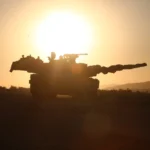 tank, sun in background