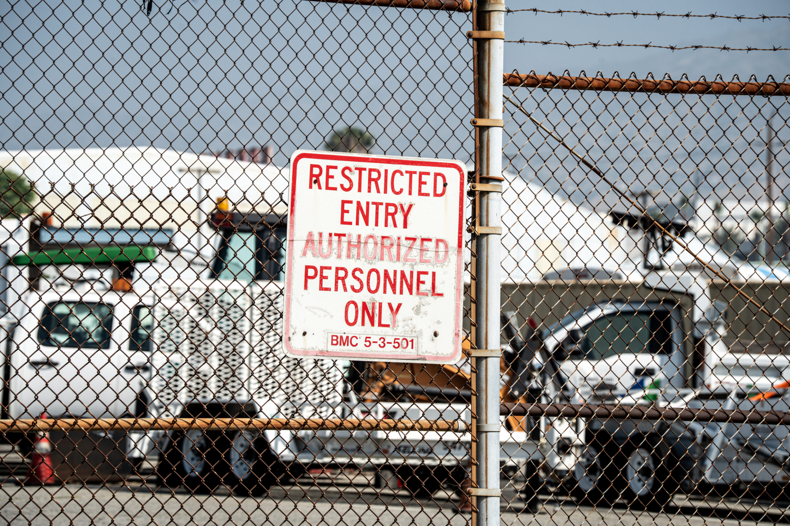 Restricted entry authorized personnel only sign on chain link fence